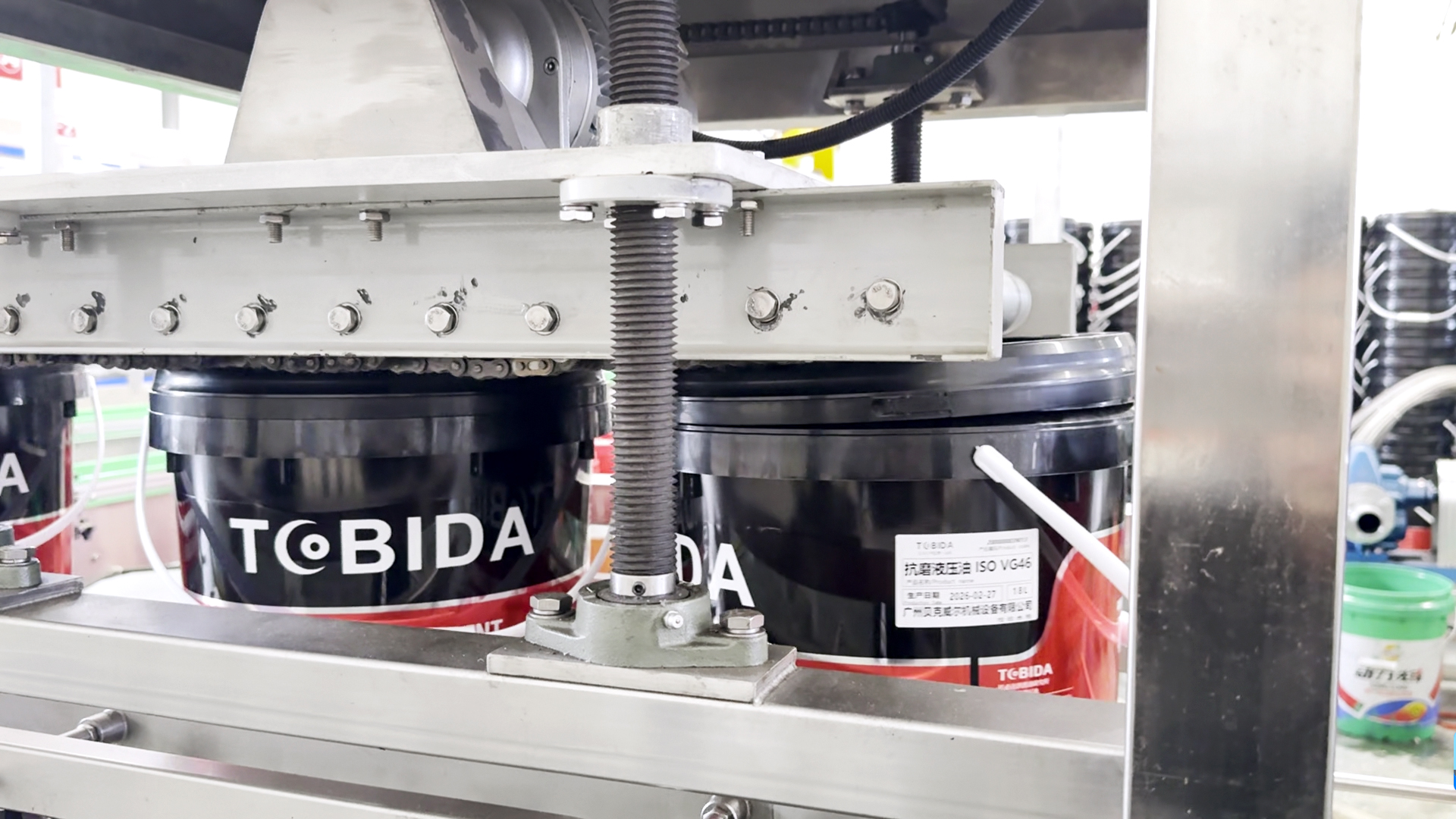 Lubricant bottles being capped after filling Lubricant bottles being capped after filling